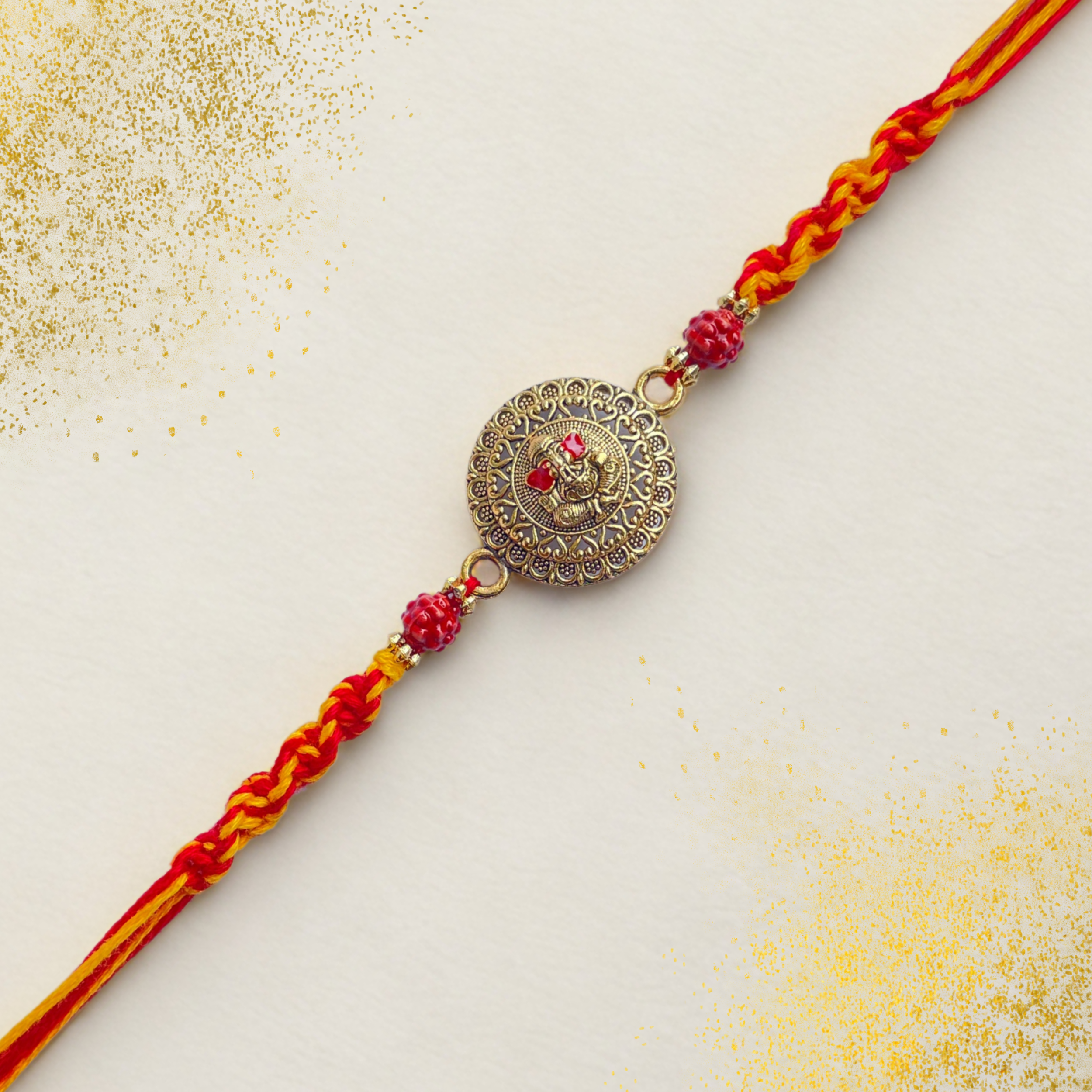 Antique Ganesha Rakhi with Red-Yellow Braided Thread